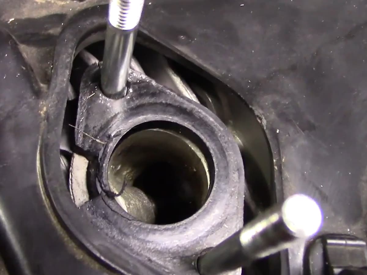 GY6 intake manifold cracked rubber flange seal showing air leak location near M6 mounting studs