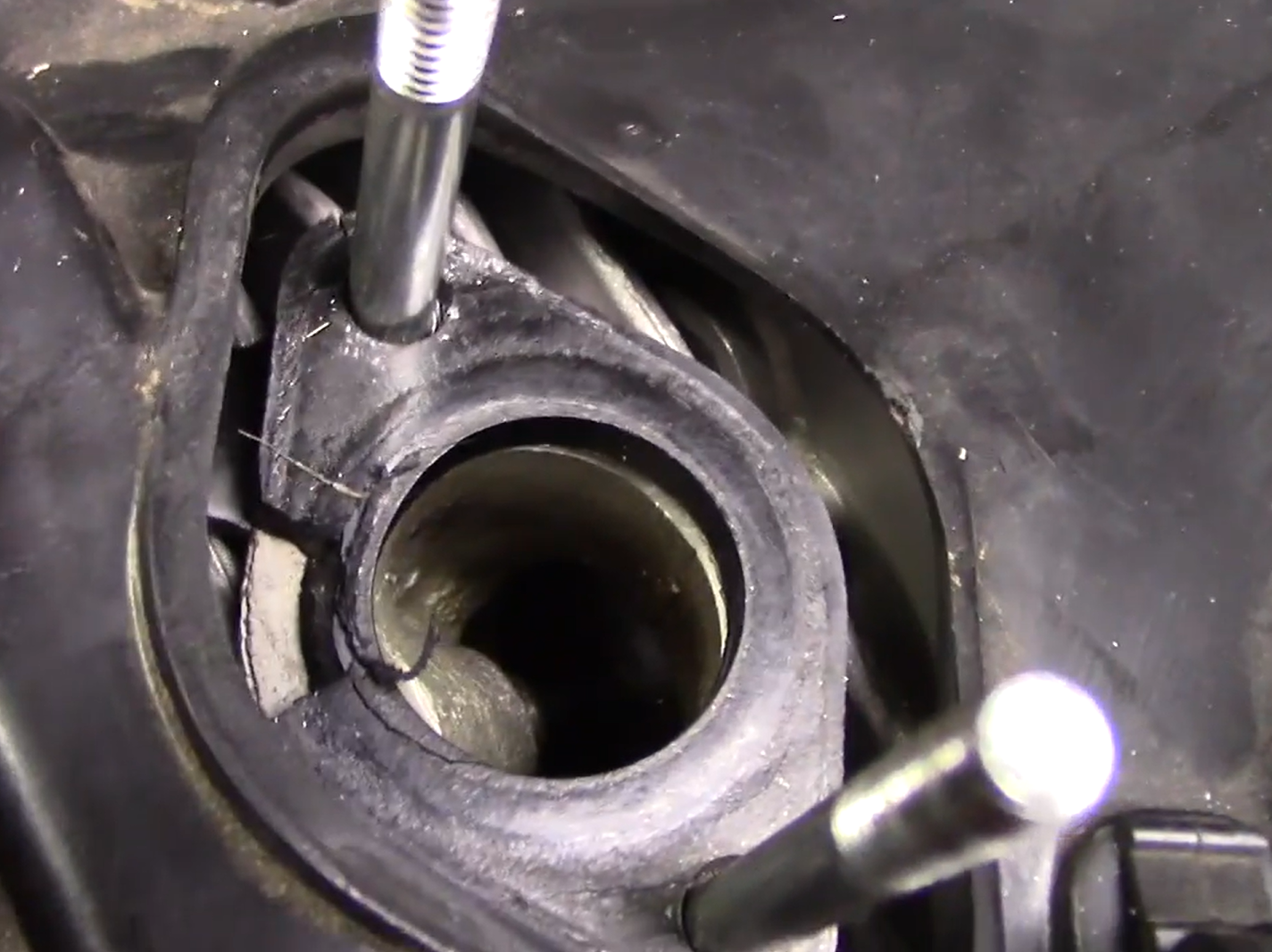 GY6 intake manifold cracked rubber flange seal showing air leak location near M6 mounting studs