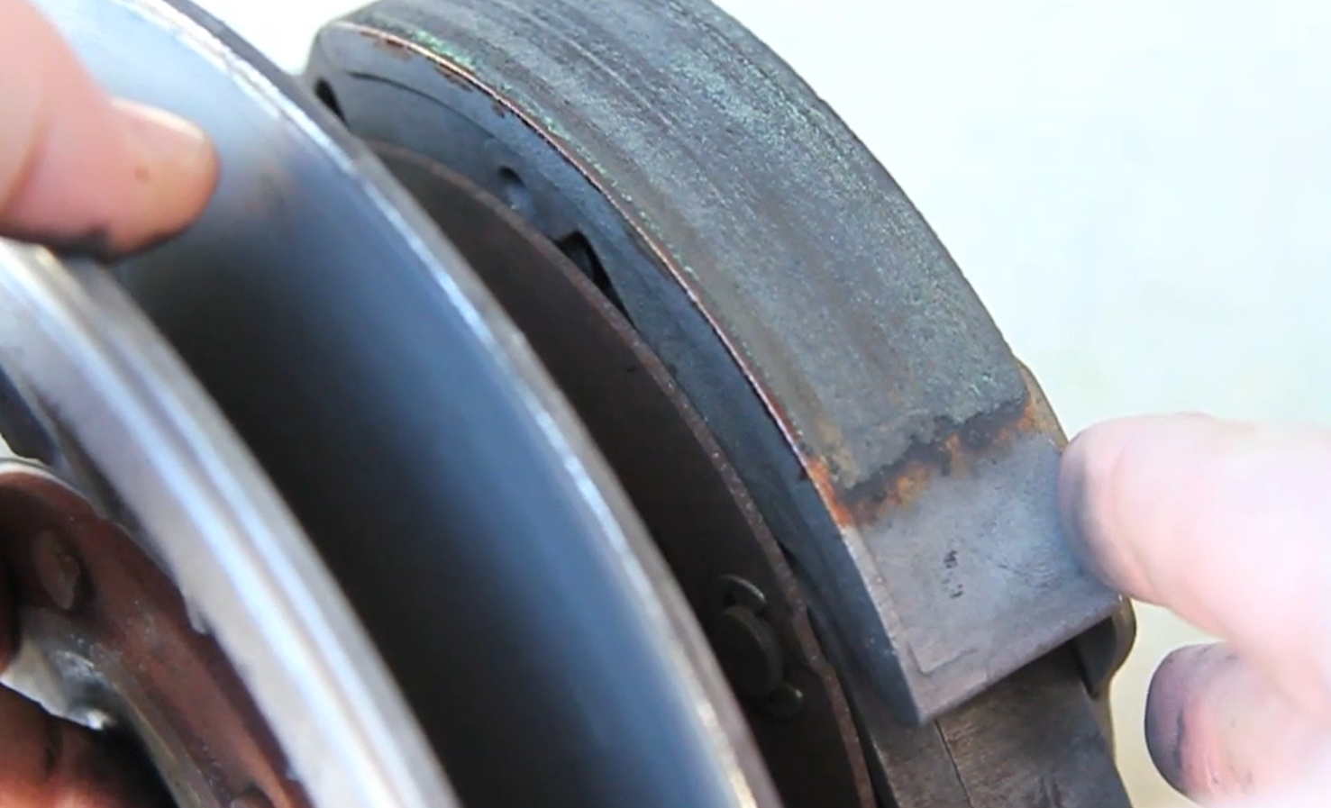 Inspecting glazed dry centrifugal clutch shoe friction pads on Suzuki Burgman 400 secondary pulley