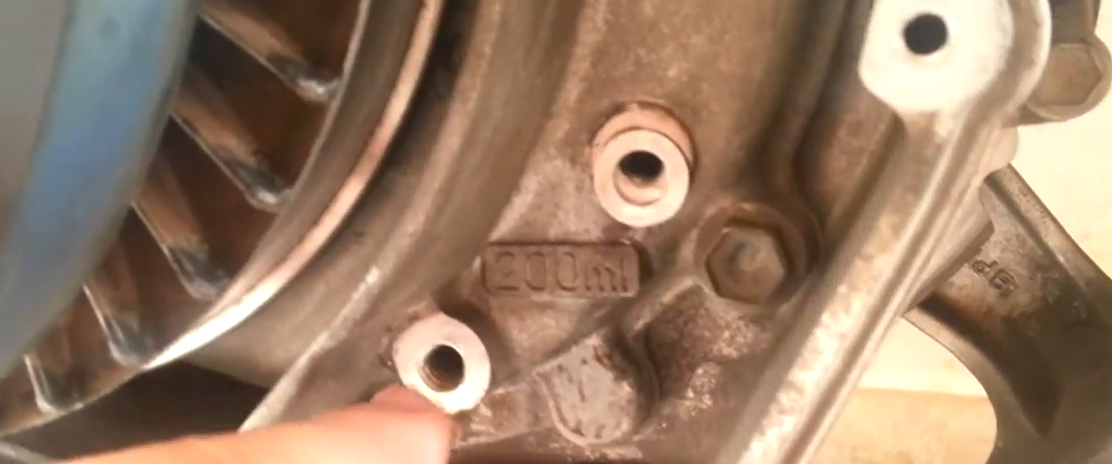 Suzuki Burgman 400 final drive gearbox casing showing 200ml oil capacity casting mark and drain bolt