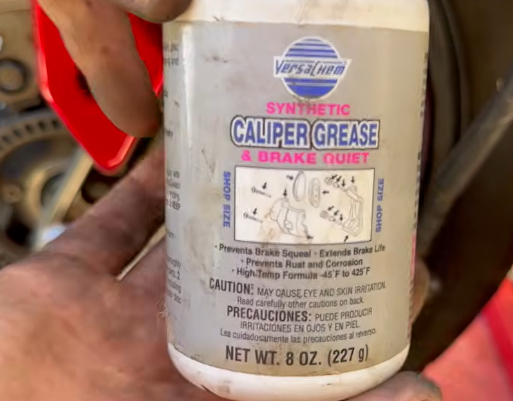 Applying silicone brake grease to the ADV 150 rear caliper slider pins before installing new pads