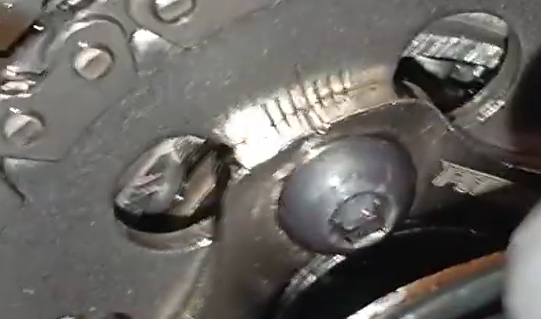 Square tappet tool holding the NMAX adjuster screw while tightening the 8mm valve locknut