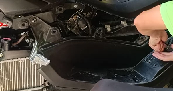 NMAX 155 cylinder head cover removed exposing the rocker arm and VVA mechanism