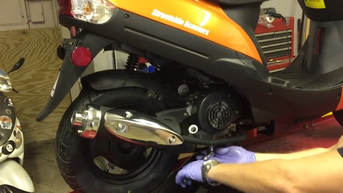 Drain plug with spring and screen filter carefully sliding back into crankcase